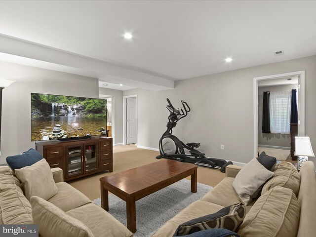 living room featuring light colored carpet, recessed lighting, and baseboards