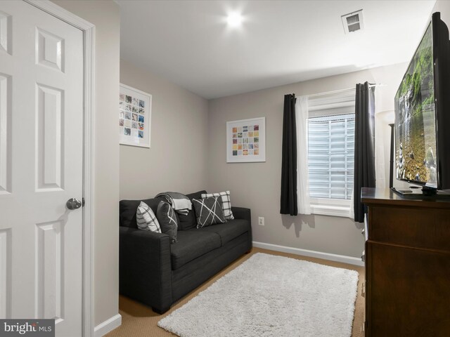 living area with baseboards and carpet flooring