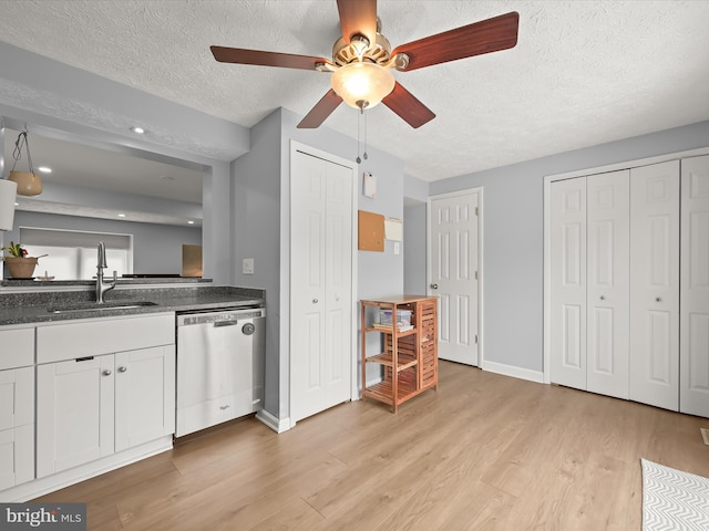 6300 Loring Dr, Columbia, MD 21045 - kitchen with stainless steel dishwasher, a sink, a textured ceiling, light wood-style floors, and a ceiling fan