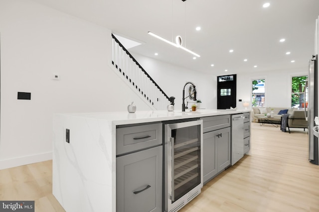 1404 Montello Ave NE, Washington, DC 20002 - indoor bar featuring wine cooler, light wood-style flooring, recessed lighting, hanging light fixtures, and stairway