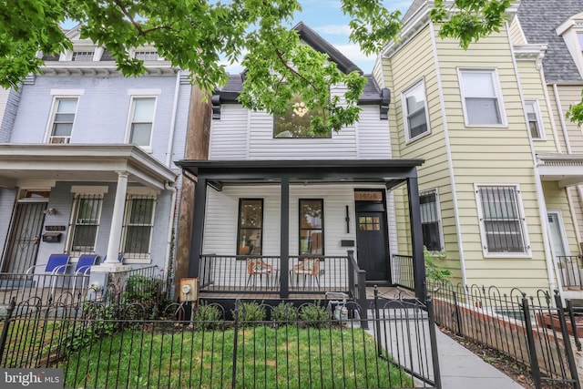 1404 Montello Ave NE, Washington, DC 20002 - townhome / multi-family property with covered porch and a fenced front yard