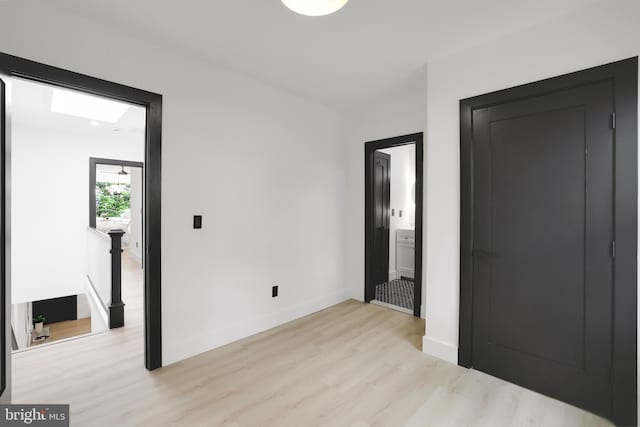 1404 Montello Ave NE, Washington, DC 20002 - unfurnished bedroom featuring light wood-style flooring, baseboards, and connected bathroom