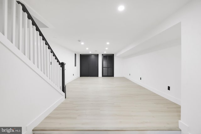 1404 Montello Ave NE, Washington, DC 20002 - unfurnished living room with light wood-style flooring, baseboards, stairway, and recessed lighting
