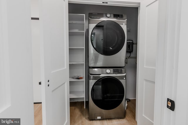 1801 Otis St NE Unit 6, Washington, DC 20018 - laundry room with stacked washer / dryer and wood finished floors