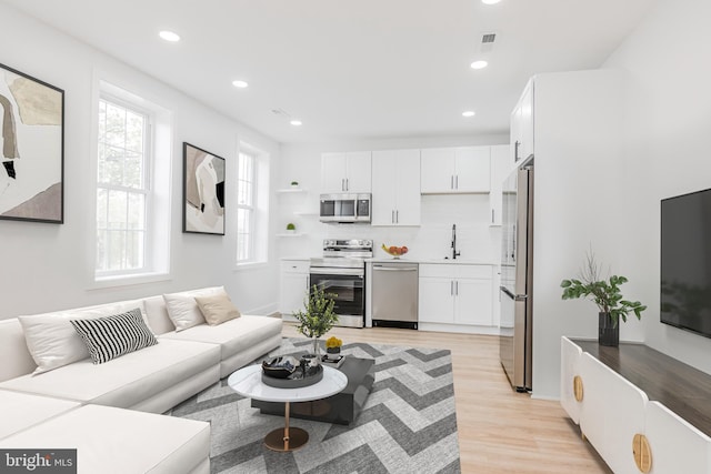 1801 Otis St NE Unit 6, Washington, DC 20018 - living area featuring light wood-style floors and recessed lighting
