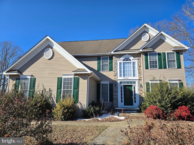 colonial house featuring stone siding