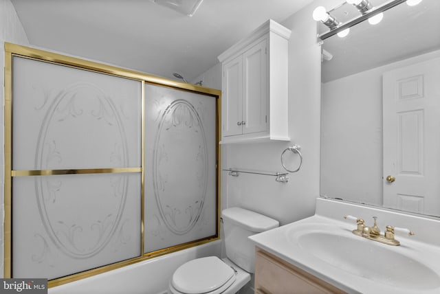bathroom with toilet, bath / shower combo with glass door, and vanity