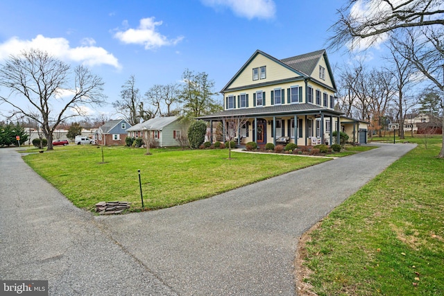 16 Glyndon Ave, Glyndon, MD 21071 - view of front facade with a porch, a front yard, and driveway