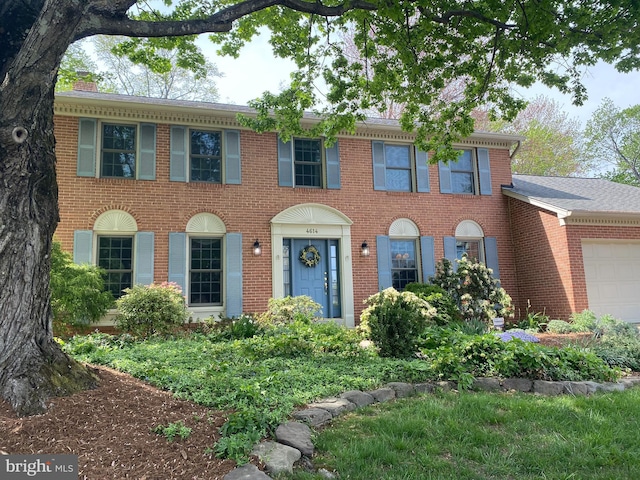 4614 Demby Dr, Fairfax, VA 22032 - colonial inspired home with an attached garage, brick siding, and a chimney