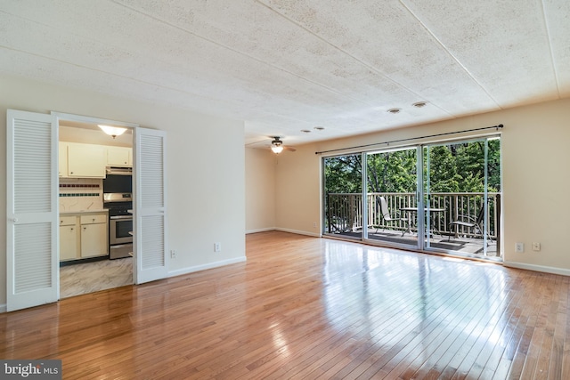 5707 Indian Ct Unit 31, Alexandria, VA 22303 - unfurnished living room with light wood finished floors, ceiling fan, and baseboards