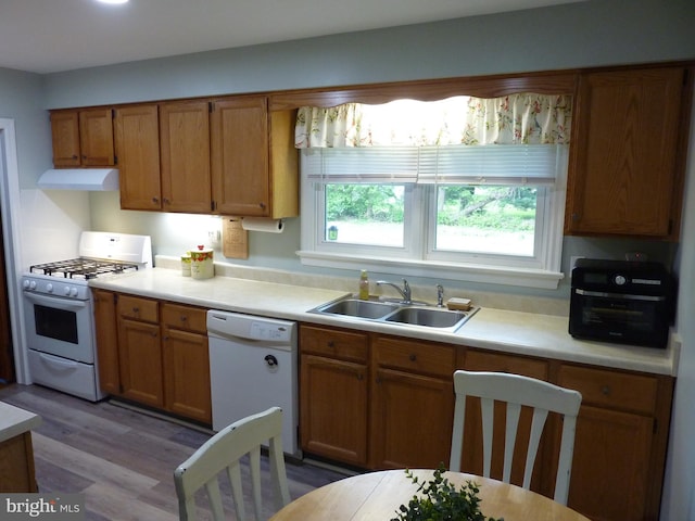 826 S Dupont Blvd, Smyrna, DE 19977 - kitchen featuring white appliances, a sink, under cabinet range hood, and light countertops