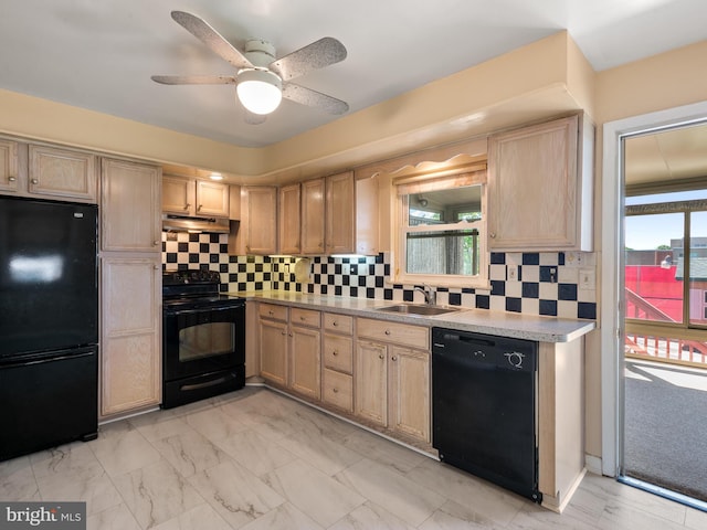 kitchen featuring black appliances, a sink, under cabinet range hood, light brown cabinetry, and backsplash
