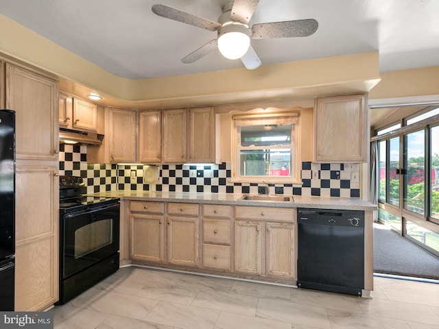 kitchen featuring black appliances, light brown cabinets, light marble finish flooring, a sink, and under cabinet range hood