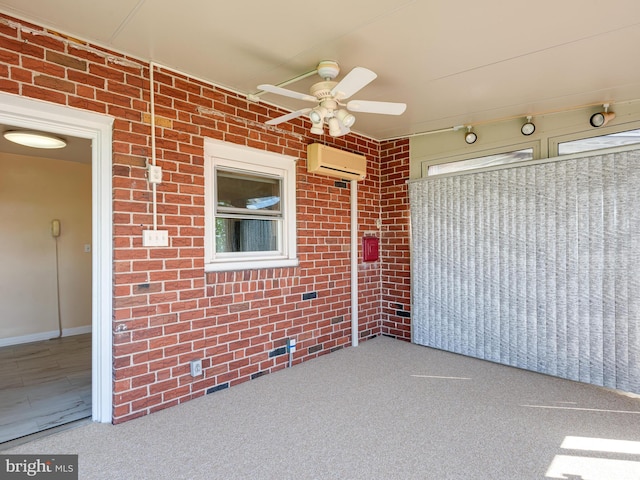 view of patio / terrace with a ceiling fan and a wall mounted air conditioner
