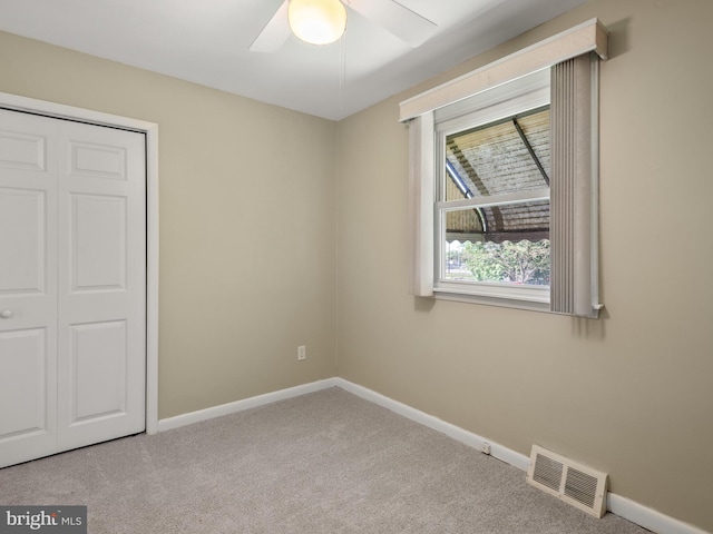 unfurnished bedroom featuring carpet, baseboards, and a closet