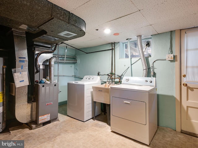 washroom with washer and dryer and heating unit