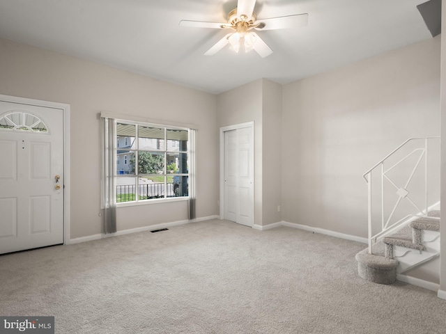 entryway featuring carpet, ceiling fan, and baseboards