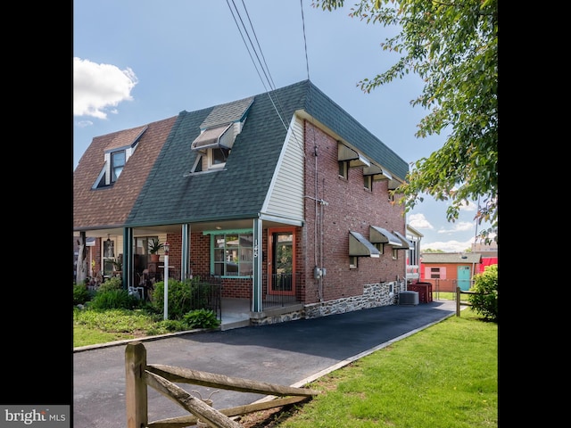 rear view of property with brick siding and central air condition unit