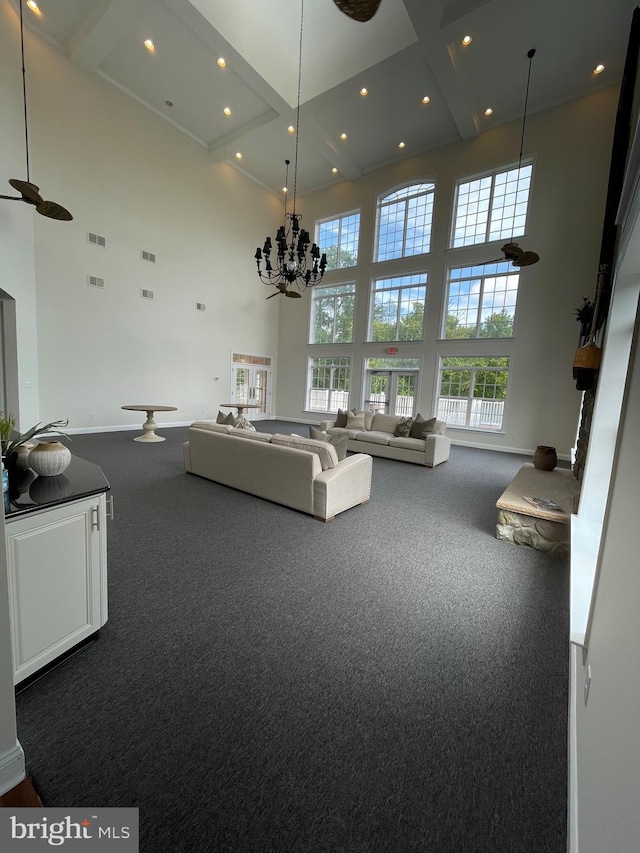 216 N Heron Ln, New Castle, DE 19720 - carpeted living area featuring a towering ceiling, baseboards, recessed lighting, beam ceiling, and a chandelier