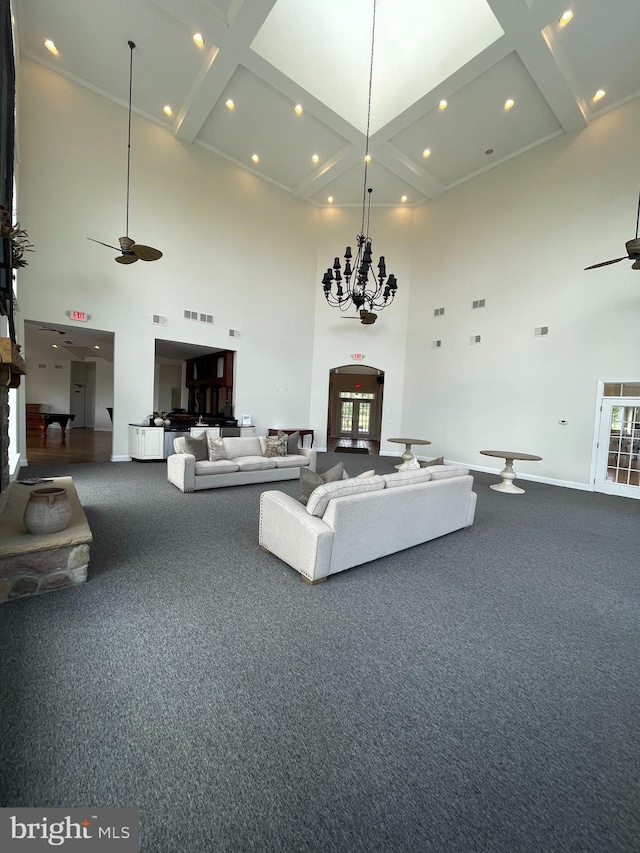216 N Heron Ln, New Castle, DE 19720 - carpeted living area with a high ceiling, ceiling fan, baseboards, a chandelier, and beam ceiling
