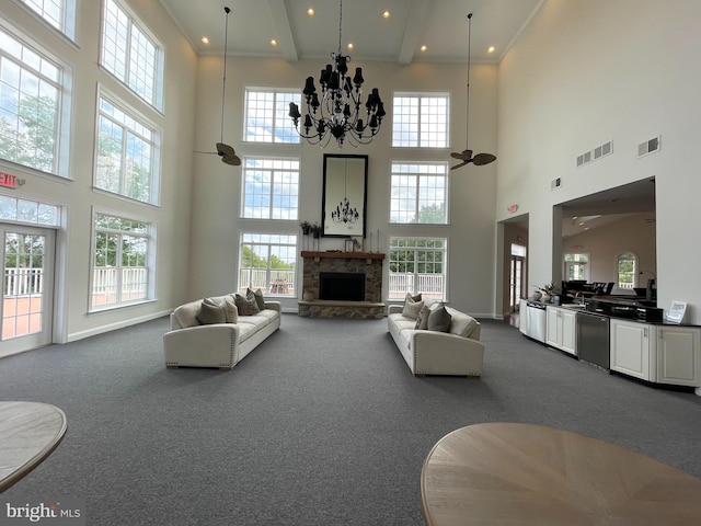 216 N Heron Ln, New Castle, DE 19720 - living room with a high ceiling, dark colored carpet, healthy amount of natural light, a stone fireplace, and a chandelier