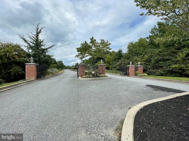216 N Heron Ln, New Castle, DE 19720 - view of asphalt road with curbs and a gated entry