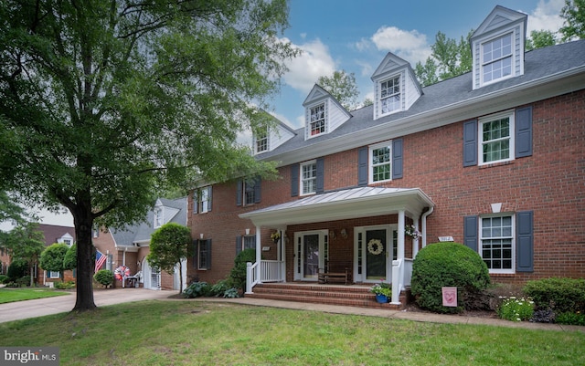 3910 Corbin Hall Ln, Fredericksburg, VA 22408 - view of front of house with brick siding, a front lawn, and a porch