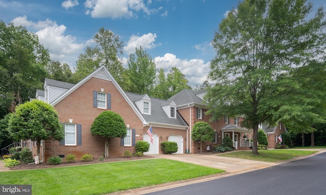 3910 Corbin Hall Ln, Fredericksburg, VA 22408 - view of front facade featuring driveway, a front yard, brick siding, and a garage