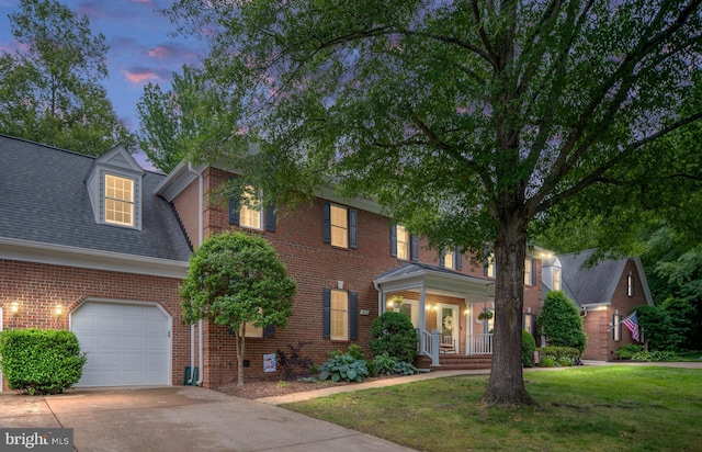 3910 Corbin Hall Ln, Fredericksburg, VA 22408 - view of front of home with brick siding, a lawn, covered porch, an attached garage, and concrete driveway