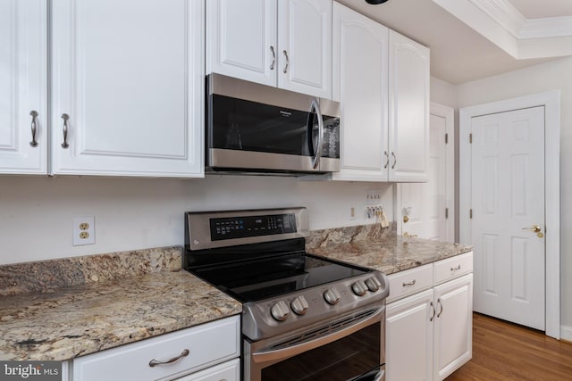 3910 Corbin Hall Ln, Fredericksburg, VA 22408 - kitchen featuring stainless steel appliances, wood finished floors, white cabinetry, crown molding, and light stone countertops