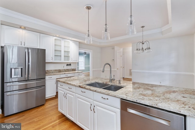 3910 Corbin Hall Ln, Fredericksburg, VA 22408 - kitchen featuring appliances with stainless steel finishes, a sink, glass insert cabinets, white cabinetry, and decorative light fixtures
