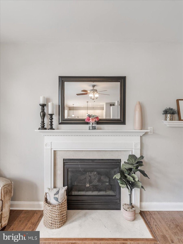 403 Joshua Ln, Middletown, DE 19709 - detailed view of a fireplace with flush hearth, wood finished floors, baseboards, and a ceiling fan