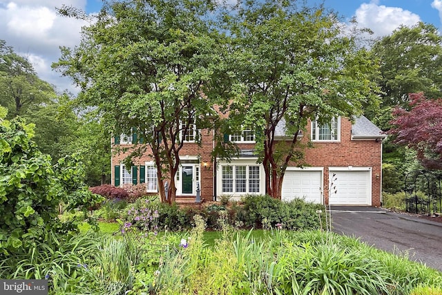 8265 Private Ln, Annandale, VA 22003 - view of front of home featuring brick siding, asphalt driveway, and a garage