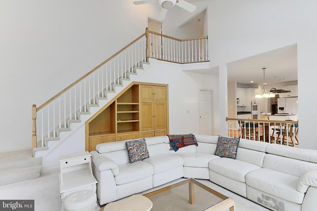 8265 Private Ln, Annandale, VA 22003 - carpeted living room featuring a towering ceiling, stairs, ceiling fan, and a chandelier