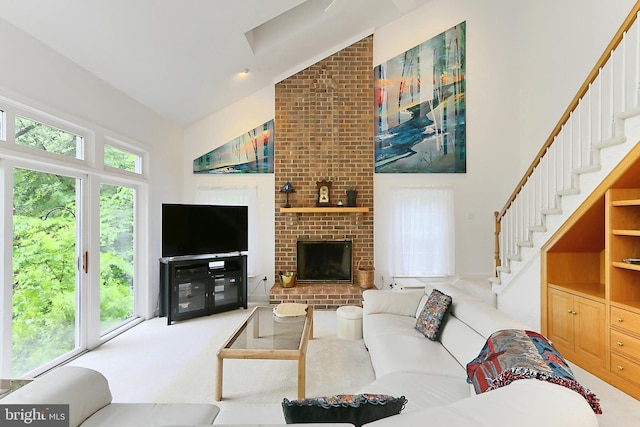 8265 Private Ln, Annandale, VA 22003 - carpeted living room featuring high vaulted ceiling, stairway, and a fireplace