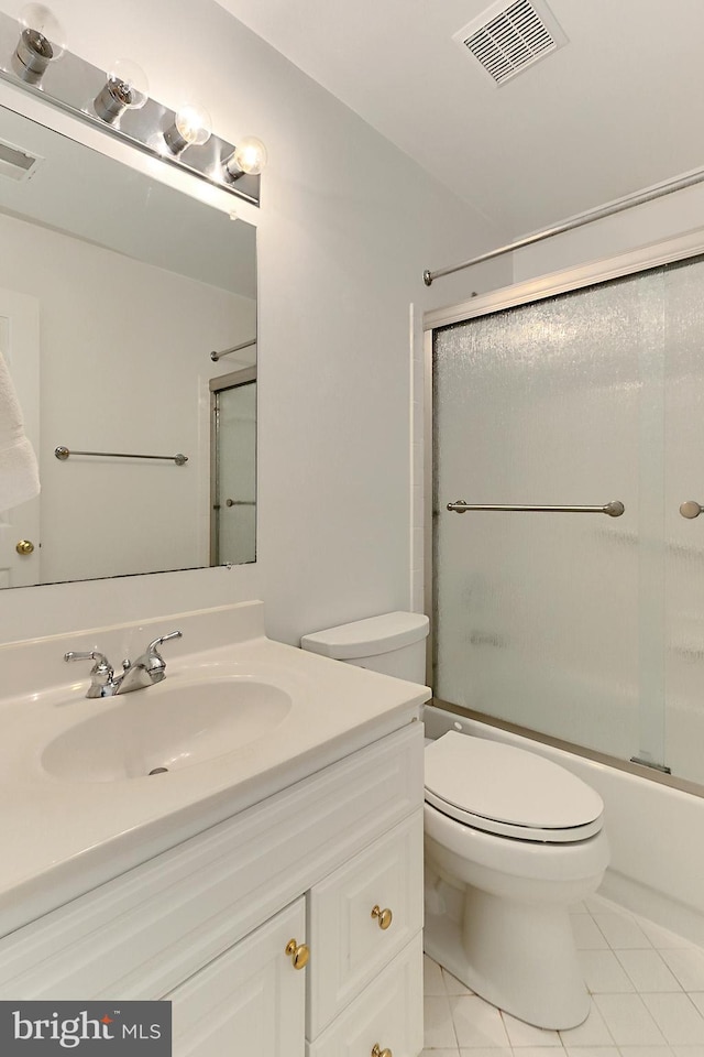 8265 Private Ln, Annandale, VA 22003 - bathroom with vanity, toilet, tile patterned flooring, and combined bath / shower with glass door
