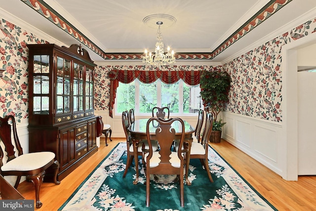 8265 Private Ln, Annandale, VA 22003 - dining space featuring wallpapered walls, a chandelier, a wainscoted wall, wood finished floors, and ornamental molding