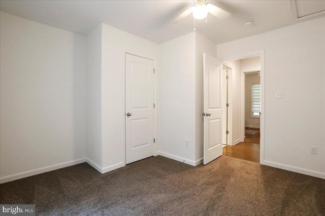 unfurnished bedroom with carpet floors, baseboards, and a ceiling fan