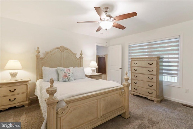 bedroom featuring light colored carpet, ceiling fan, and baseboards