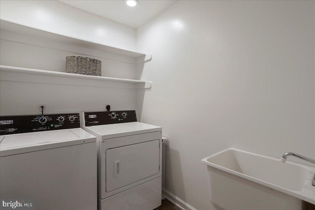 laundry area with washing machine and clothes dryer, baseboards, and recessed lighting