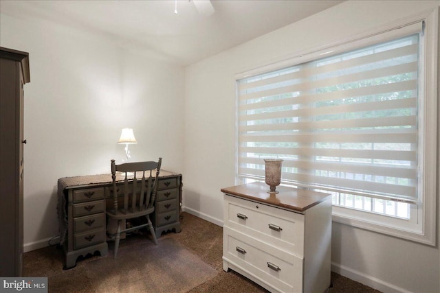 office area featuring dark carpet, plenty of natural light, and baseboards