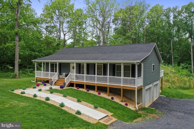 view of front of property with a porch, a garage, a front yard, asphalt driveway, and a shingled roof