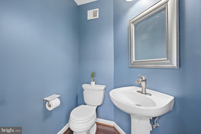 713 Norfolk Ln, Alexandria, VA 22314 - bathroom featuring toilet, baseboards, a sink, and wood finished floors