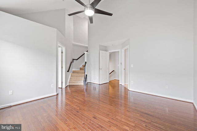 713 Norfolk Ln, Alexandria, VA 22314 - unfurnished living room featuring high vaulted ceiling, a ceiling fan, wood finished floors, baseboards, and stairs