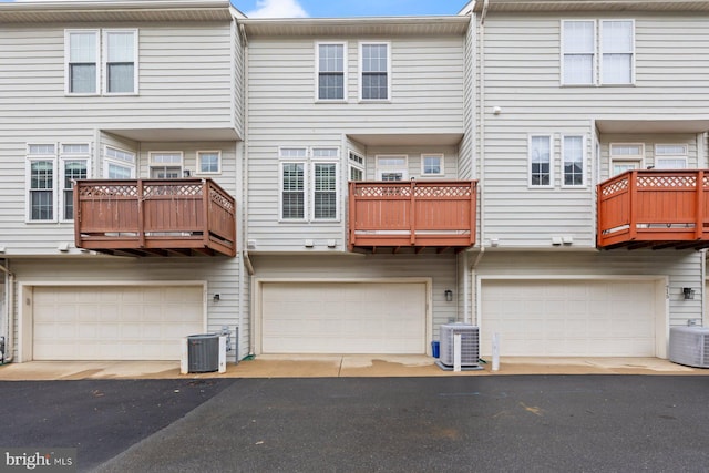 713 Norfolk Ln, Alexandria, VA 22314 - back of property featuring central AC unit, a garage, and a balcony