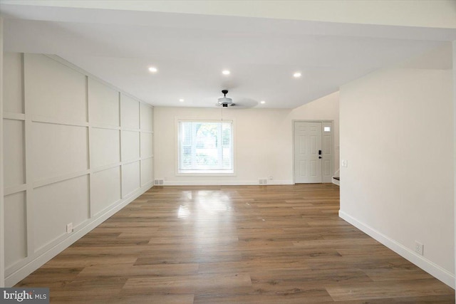 unfurnished room with wood finished floors, a ceiling fan, baseboards, and recessed lighting