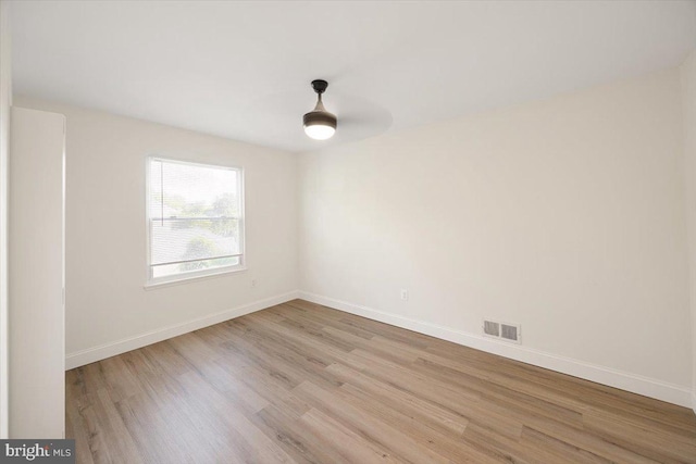 unfurnished room featuring light wood-style flooring and baseboards