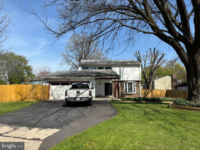 view of front facade featuring asphalt driveway and a garage