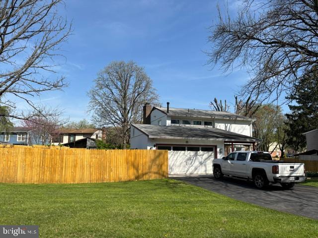 view of home's exterior with an attached garage and driveway