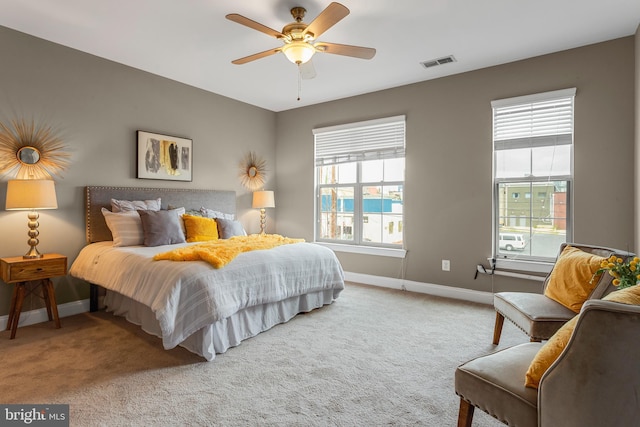 3911 Fleet St, Baltimore, MD 21224 - carpeted bedroom featuring baseboards, multiple windows, and ceiling fan